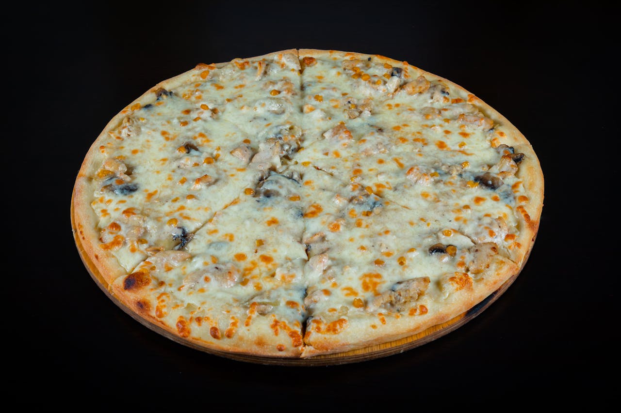 services-01 Close-up of a delicious mushroom and cheese pizza on a dark backdrop, perfectly baked.